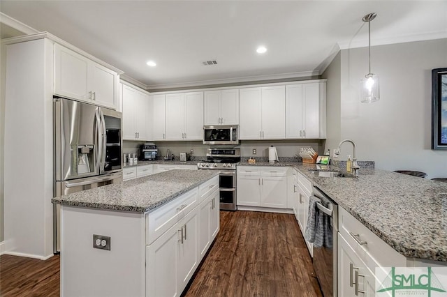 kitchen featuring pendant lighting, sink, dark hardwood / wood-style floors, white cabinetry, and stainless steel appliances