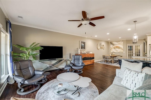 living room with dark hardwood / wood-style floors, ceiling fan, and crown molding