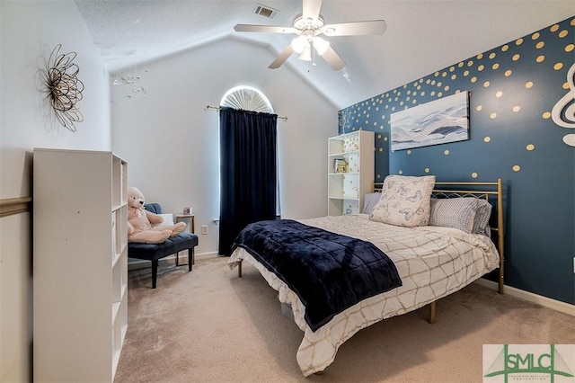 bedroom with a textured ceiling, ceiling fan, light carpet, and vaulted ceiling