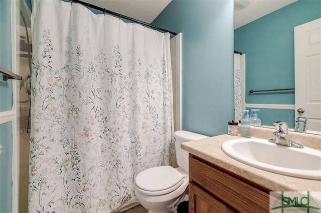 bathroom featuring vanity, a textured ceiling, toilet, and curtained shower