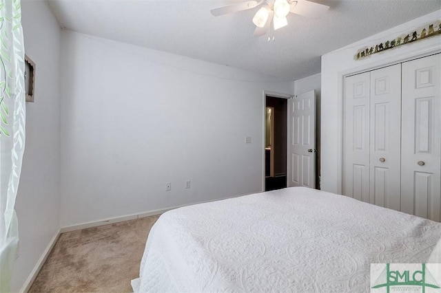 carpeted bedroom featuring ceiling fan and a closet