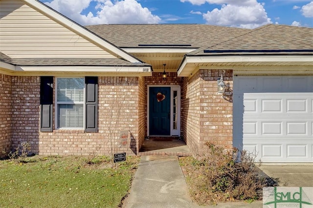 view of exterior entry with a garage