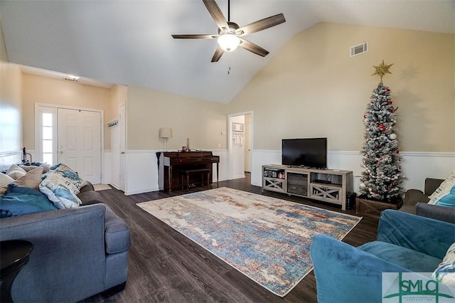 living room featuring dark hardwood / wood-style floors, ceiling fan, and vaulted ceiling