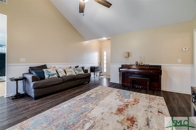 living room with ceiling fan, dark hardwood / wood-style flooring, and lofted ceiling