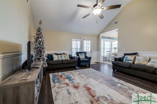 living room featuring dark hardwood / wood-style floors, ceiling fan, and vaulted ceiling