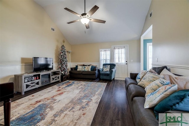 living room with ceiling fan, dark hardwood / wood-style flooring, and vaulted ceiling