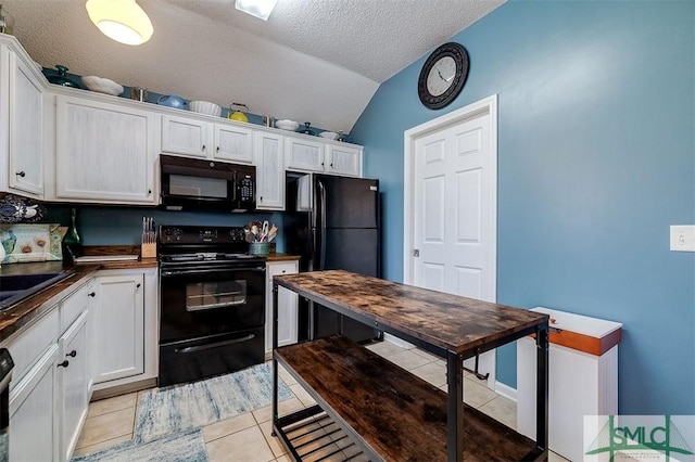 kitchen featuring white cabinets, a textured ceiling, vaulted ceiling, light tile patterned flooring, and black appliances