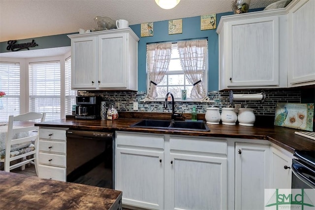 kitchen with white cabinets, decorative backsplash, black dishwasher, and sink