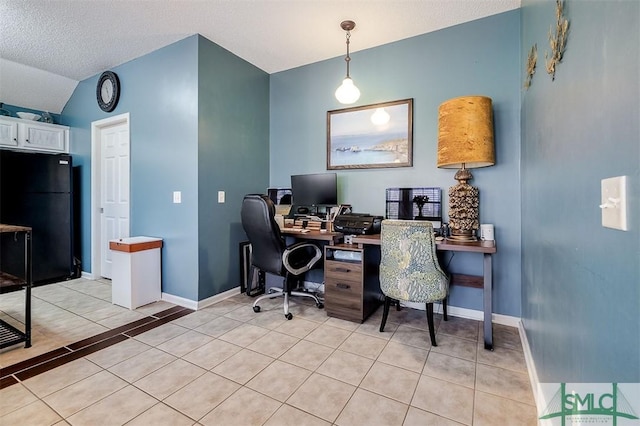 office area with a textured ceiling, light tile patterned floors, and lofted ceiling