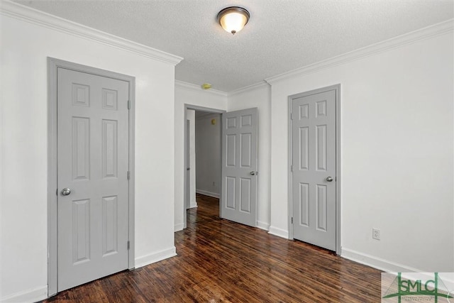 unfurnished bedroom featuring crown molding, dark hardwood / wood-style flooring, and a textured ceiling