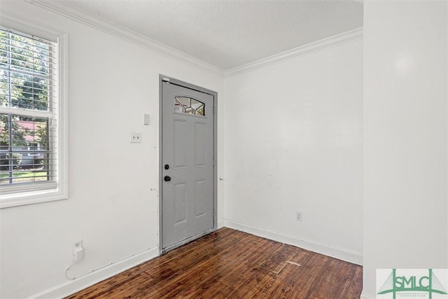 entrance foyer featuring a textured ceiling, dark hardwood / wood-style flooring, and crown molding