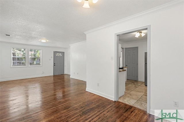 unfurnished room with hardwood / wood-style floors, ornamental molding, and a textured ceiling