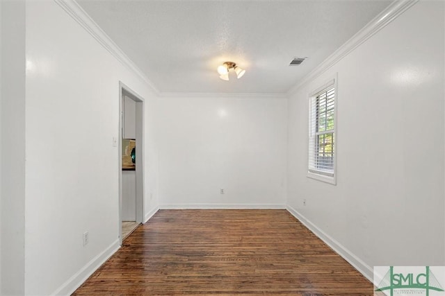 unfurnished room featuring dark hardwood / wood-style flooring, a textured ceiling, and ornamental molding