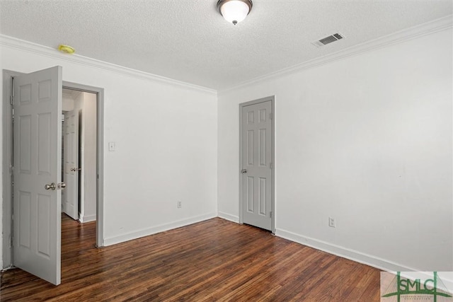 spare room featuring a textured ceiling, crown molding, and dark hardwood / wood-style floors