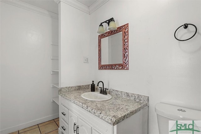 bathroom featuring toilet, tile patterned flooring, vanity, and ornamental molding