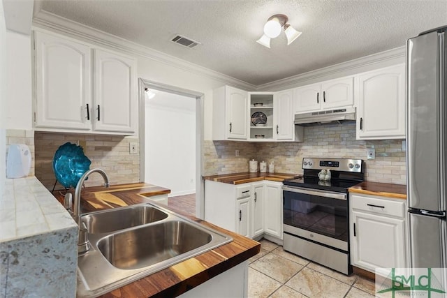 kitchen with white cabinets, appliances with stainless steel finishes, wood counters, and sink