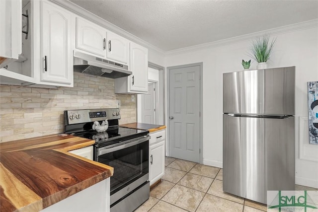 kitchen with appliances with stainless steel finishes, ornamental molding, a textured ceiling, white cabinets, and butcher block countertops