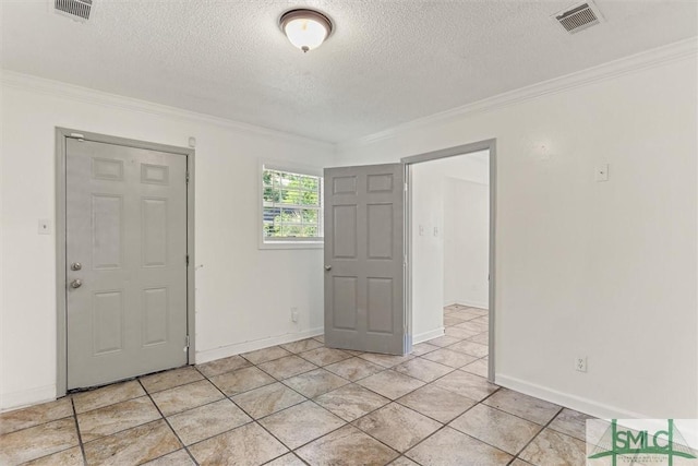 empty room with a textured ceiling and crown molding