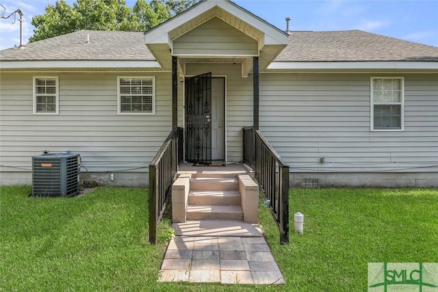 exterior space featuring central air condition unit and a front lawn