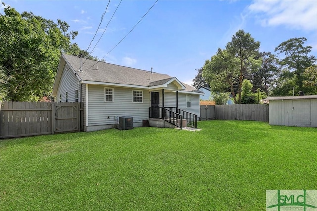 back of house with a lawn and a storage shed