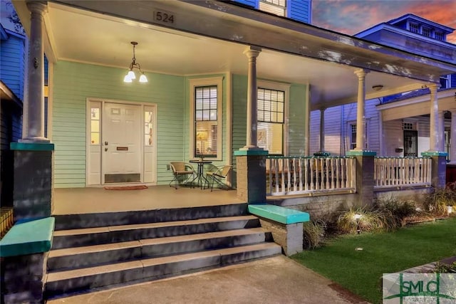 524 E Duffy St, Savannah, GA 31401 - exterior entry at dusk featuring a porch