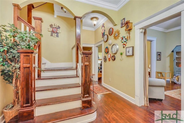 stairs featuring ornate columns, hardwood / wood-style floors, and ornamental molding