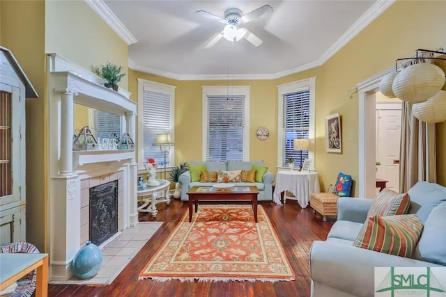 sitting room featuring a tile fireplace, ceiling fan, crown molding, and hardwood / wood-style flooring