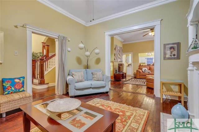 sitting room with hardwood / wood-style floors, ceiling fan, and crown molding