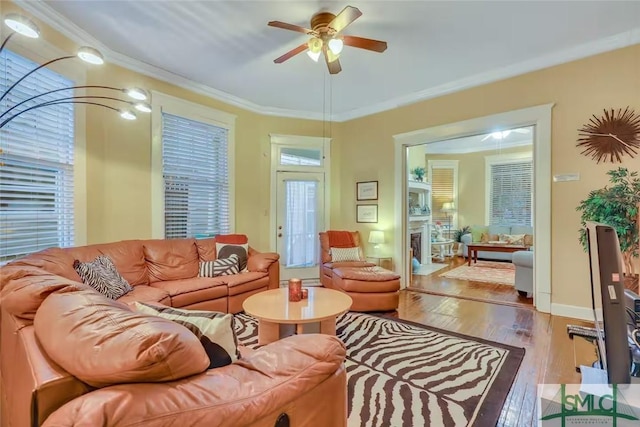 living room with light wood-type flooring, ceiling fan, and ornamental molding