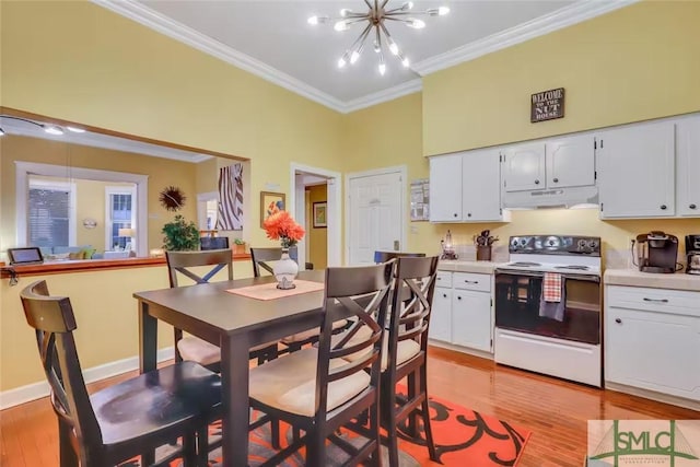 kitchen featuring white cabinets, an inviting chandelier, white range with electric stovetop, and ornamental molding