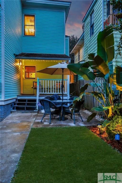 patio terrace at dusk with a yard