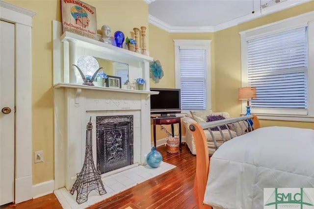 524 E Duffy St, Savannah, GA 31401 - bedroom with ornamental molding, wood finished floors, and a fireplace with flush hearth