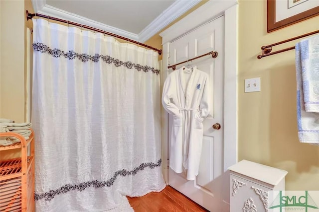 bathroom with hardwood / wood-style floors and crown molding