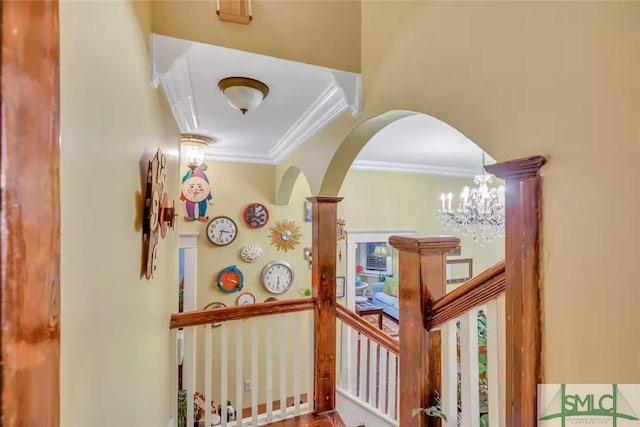 524 E Duffy St, Savannah, GA 31401 - corridor featuring ornamental molding, arched walkways, an upstairs landing, and a chandelier