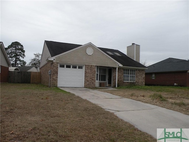 ranch-style house featuring a garage and a front lawn