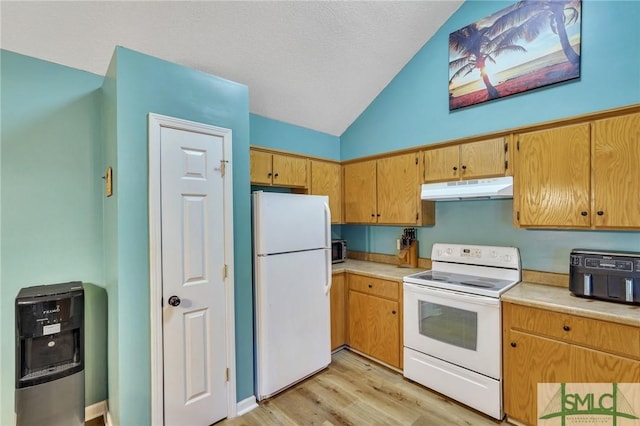 kitchen with light wood-type flooring, white appliances, heating unit, and vaulted ceiling