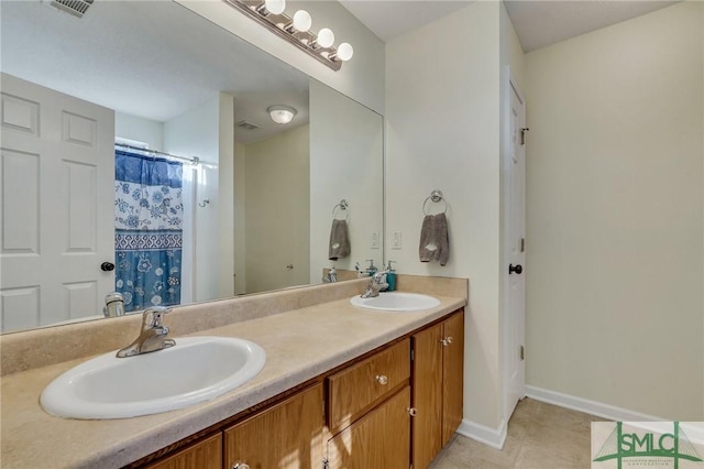 bathroom with tile patterned flooring and vanity