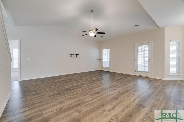 unfurnished living room featuring wood-type flooring, vaulted ceiling, and ceiling fan