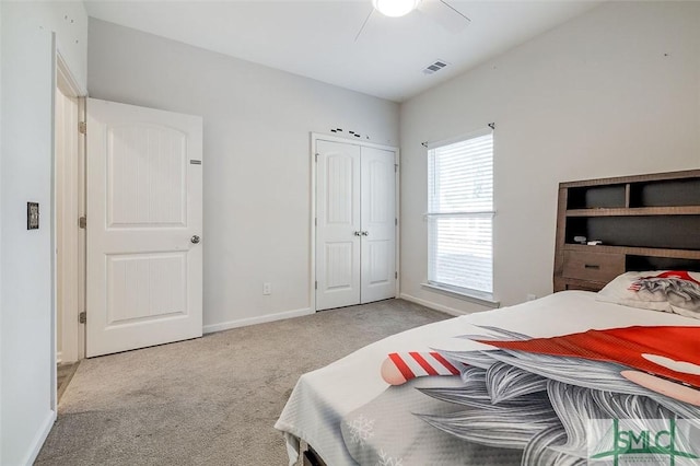 carpeted bedroom with ceiling fan and a closet