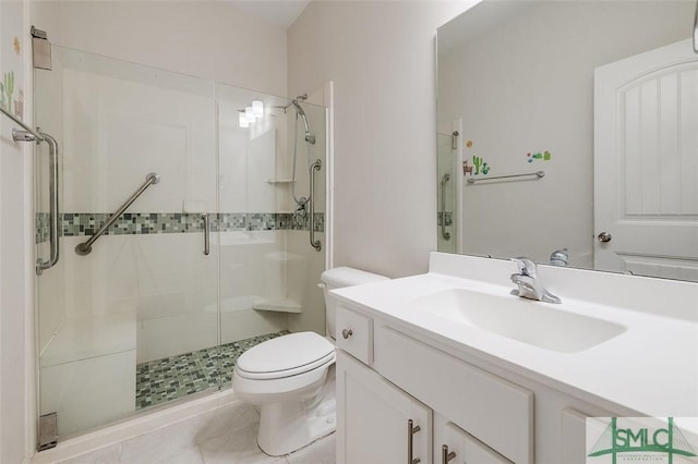 bathroom featuring tile patterned flooring, vanity, toilet, and walk in shower