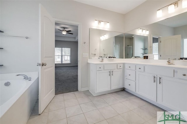 bathroom featuring a bath, vanity, tile patterned floors, and ceiling fan