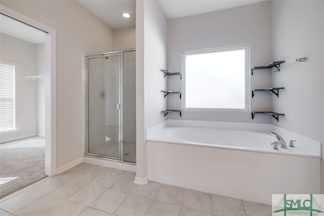 bathroom featuring tile patterned floors and independent shower and bath