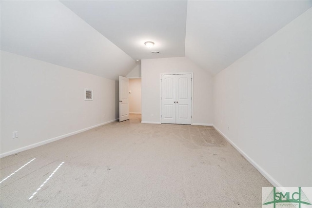 bonus room featuring light colored carpet and lofted ceiling