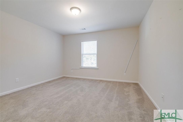 unfurnished room featuring light colored carpet