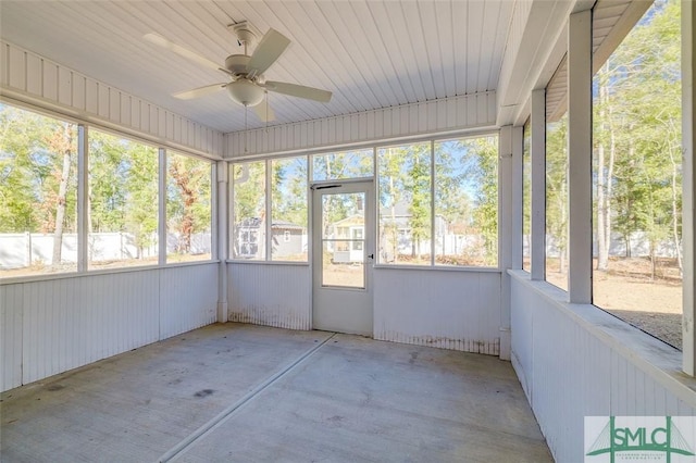 unfurnished sunroom featuring ceiling fan