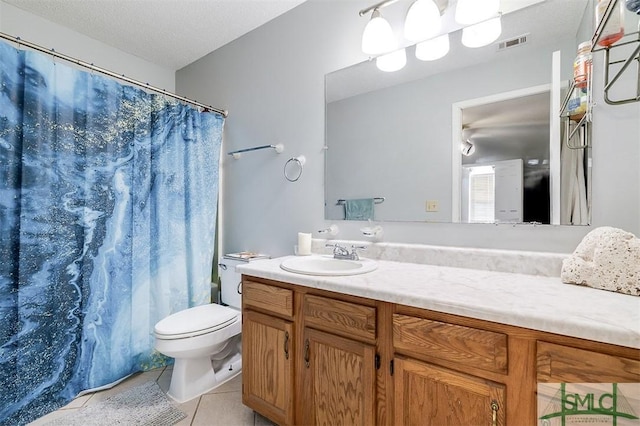 bathroom featuring walk in shower, tile patterned flooring, a textured ceiling, toilet, and vanity