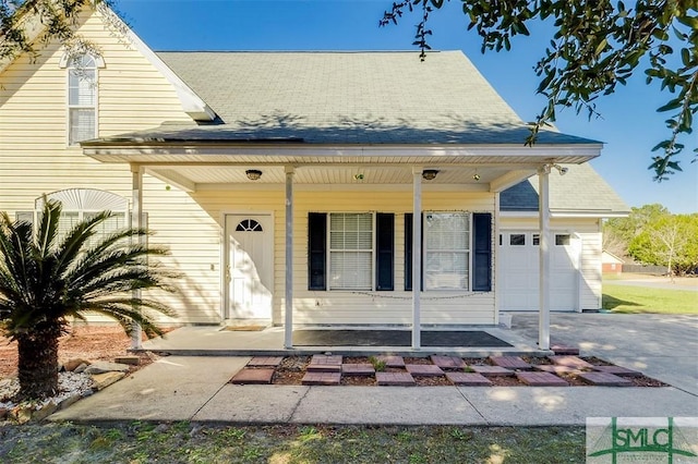 view of front of property with covered porch and a garage