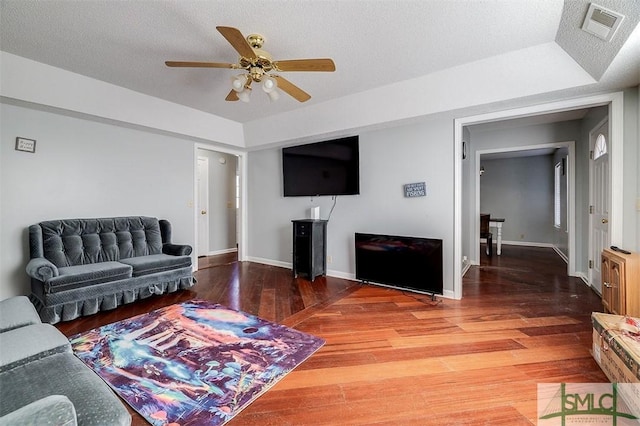 living room featuring ceiling fan and hardwood / wood-style floors