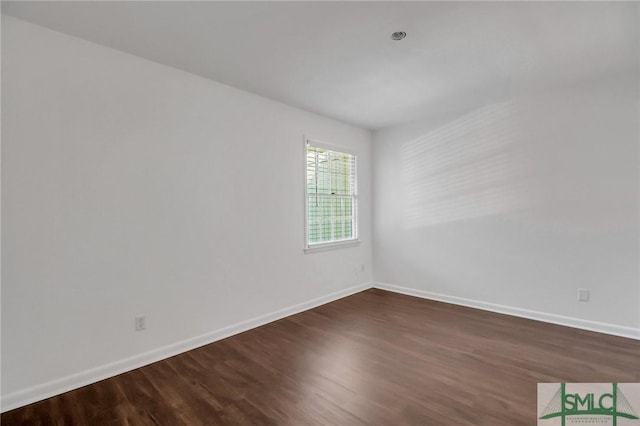 spare room featuring dark wood-type flooring