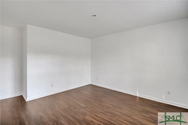 unfurnished room featuring dark wood-type flooring